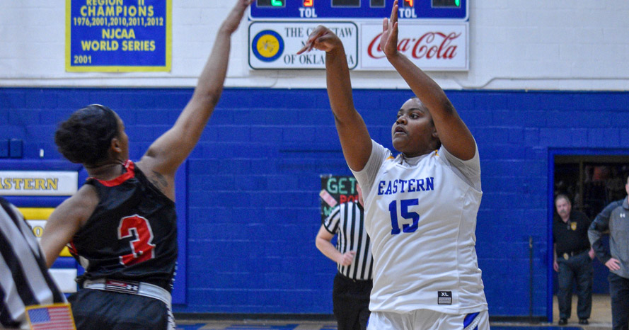 McKenzie Patton shoots a three-pointer over a defender.